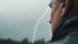 © MAKASIHMAS SIDNEY - Man watching lightning storm outdoors