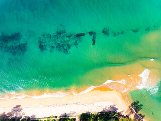 Wall Mural - Summer seascape beautiful waves,Tropical sea water in sunny day, Top view from drone camera,Amazing ocean colorful nature background, Beautiful bright sea waves splashing on beach sand