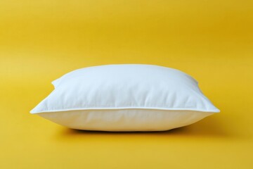 Wall Mural - A White Square Pillow Against A Bright Yellow Background