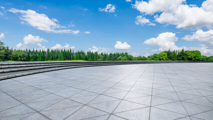 Wall Mural - empty square floor and green forest with sky clouds in park