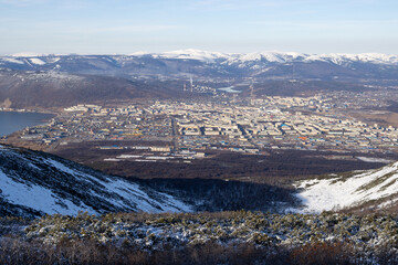 Wall Mural - View from the mountain to the city of Magadan. A large northern city located on the sea coast among the mountains. Beautiful northern nature. Magadan, Magadan region, Far East of Russia.