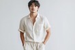 © kura - A handsome man in a light colored casual button down shirt