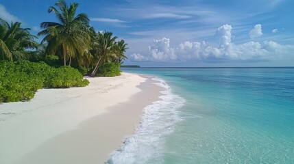 White sandy tropical beach with ocean waves and serene skies