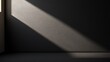 © MontichaSom - A sunbeam highlights a minimalist interior space, creating a dramatic contrast with the dark walls.