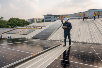 Wall Mural - Engineer service check installation solar cell on the roof of factory. Silhouette technician inspection and repair solar cell on the roof of factory. Technology solar energy renewable.