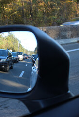 Fototapete - Reflection of the highway road with traffic trouble in a side rear view mirror of a moving car. Vertical stock photo for traffic jam on a suburban highway
