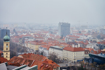 Poster - Graz cityscape on foggy day. Panoramic view of Graz, Austria with historical architecture. Streets with red roofed buildings in European city