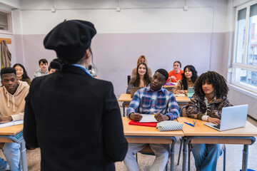 Teacher giving lesson to high school students in classroom