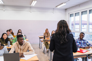 Wall Mural - High school teacher giving lesson to diverse group of students