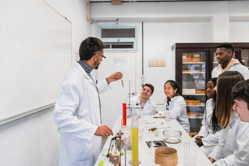 Canvas Print - Chemistry teacher showing test tube to high school students during experiment