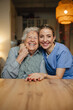 © Halfpoint - Portrait of caring healthcare worker visiting a senior patient at home, hugging her.
