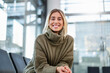 © Westend61 - Smiling woman in a sweater at the office