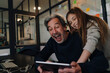 © Westend61 - Happy casual senior buisinessman and girl using tablet in office