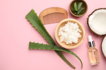 Wall Mural - Hair treatment. Coconut butter, cosmetic product, comb and aloe leaves on pink background, flat lay