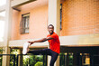 © Westend61 - Young sportive man doing stretching exercise outdoors
