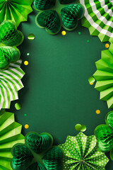 Wall Mural - Happy St. Patrick's Day frame. Flat lay composition with decorative paper fans, honeycomb clover leaves, gold confetti on dark green background