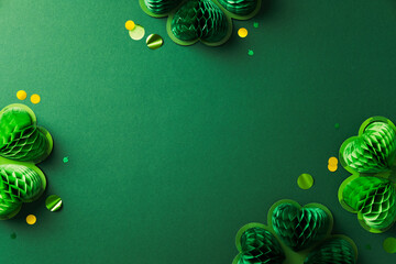 Wall Mural - St Patrick's Day celebration background. Festive honeycomb paper shamrocks with golden confetti on dark green table. Top view.