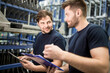 © Westend61 - Two workers with clipboard and tablet in factory warehouse