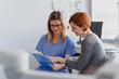 © Halfpoint - Female doctor consulting with a female patient, discussing test result in doctor office.