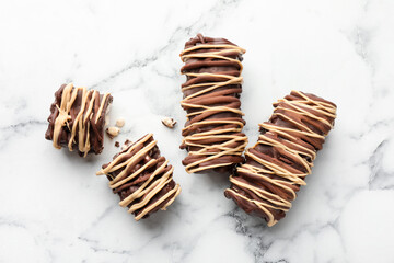 Wall Mural - Delicious chocolate puffed rice bars on white marble table, flat lay