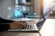 © vilaiporn - Conceptual image of a person working on a laptop in a futuristic workspace with digital icons representing technology.