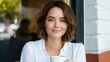 © iuricazac - Woman holding cup, outdoors at cafe.