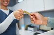 © Meeko Media - Healthcare Professional Receiving Credit Card Payment for Medical Services in Reception Area