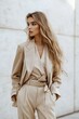 © Inna beauty - A chic woman elegantly poses in a beige suit, reflecting confidence and modern fashion sensibilities.
