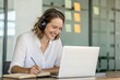 © Design Zone - Happy Woman in Headphones Taking Online Course
