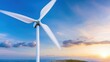 © watcharee - A wind turbine stands tall against a vibrant sky, capturing renewable energy as the sun sets on the horizon.
