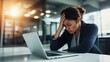 © STDG - Worried Japanese Woman in Casual Attire Sitting at Desk with Laptop