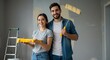 © rdkcho - Happy smiling young couple painting interior walls of housr renovating their new house