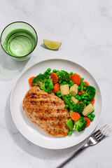 Wall Mural - grilled  chicken breast with cooked  vegetables on white plate, healthy weight loss meal,