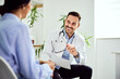 © bnenin - Doctor Engaging With Patient in a Bright, Friendly Medical Office Setting