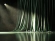© serdon - A vacant stage awaits a performance, set against a backdrop of green curtains