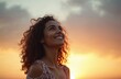 Young curly woman looking up at sky during sunset golden hour. Smiling female admires evening landscape, enjoying freedom, dream, warm sunlight. Positive emotion, inspiration concept. Happiness,