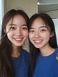 © wittoom - Smiling Asian Young Women Standing Shoulder to Shoulder in Blue Tops Posing in Front of Window Light