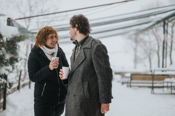 Poster - A pair of friends sharing a conversation while holding cups of hot drink in a snowy outdoor setting, exuding warmth, joy, and connection.