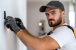 © Milos - A focused worker diligently installing wall fixtures, capturing the attention to detail and craftsmanship that goes into home renovations and interior design projects.