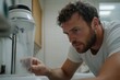 © Milos - A technician examines a blender closely, showcasing meticulous attention to detail while ensuring the appliance functions correctly in a household setting.