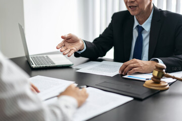 Aufkleber - A man and a woman are sitting at a table with papers and a laptop