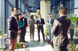 © Studio Romantic - Boss and group of happy business people standing in lobby of modern office. Multicultural team smiling looking at business man. Concept business success, employee appreciation day, common group