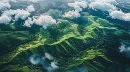 Wall Mural - Aerial view of lush green mountain range under scattered clouds with morning sunlight. Nature landscape and tranquility concept