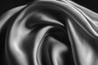 © Alla - A close-up shot of a smooth satin fabric in black and white