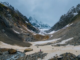 Wall Mural - couple against background moraine Chalaadi Glacier Caucasus mountains,aerial view