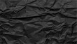 © aura studio - Black crumpled and creased paper poster, grunge texture background, old rough surface, dark distressed fold marks, vintage wrinkled sheet, artistic abstract backdrop