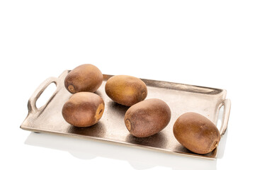 Wall Mural - Four sweet kiwis on a metal tray, close-up, isolated on a white background.