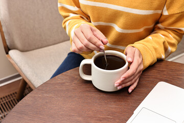 Wall Mural - Woman having coffee break at wooden table in cafe, closeup