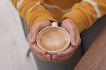 Wall Mural - Coffee break. Woman with cup of hot drink indoors, closeup