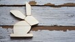 © M - A wooden rabbit silhouette on rustic wood, ideal for kids' decor.